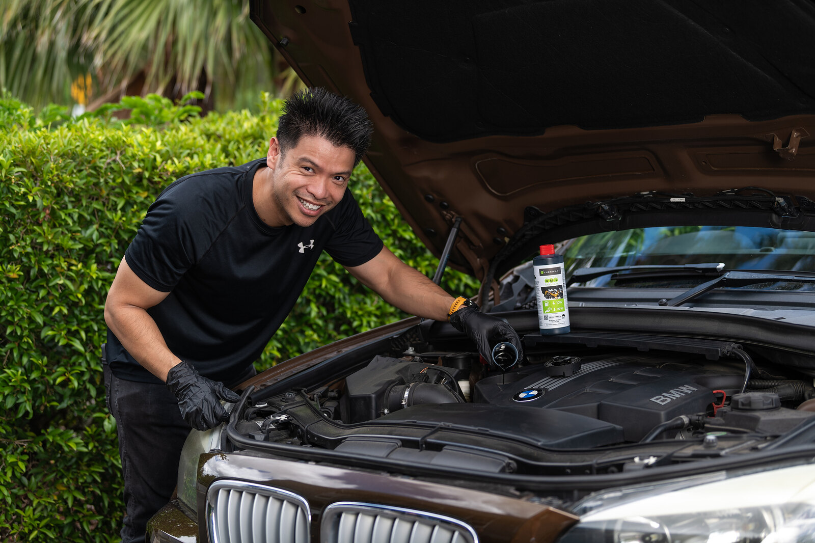 G® LUBRICANT bottle beside an open vehicle engine